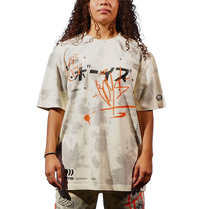 Person wearing a beige t-shirt with graphic designs on a white background